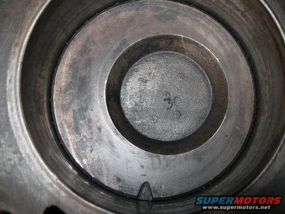 Engine cylinder interior with '30' marking and screw heads