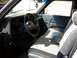 1994 Ford Explorer - The interior of a truck shows the dashboard, steering wheel, and passenger seat with fabric upholstery.