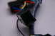 2003 Ford Taurus - Close-up of a black plastic wiring harness connector with visible colored wires and text on the cable.