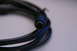 2003 Ford Taurus - Coiled black audio cable with a multi-pin connector visible.