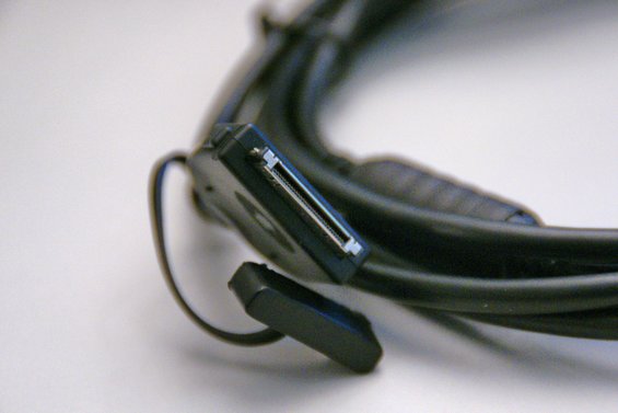 Black iPod connection cable with a 30-pin connector and protective cap