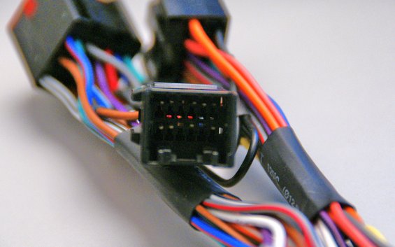 Wiring harness connector with multiple colored wires and a black plastic housing