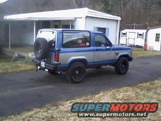 Blue and silver 1985 Ford Bronco II, 3q-front view, spare tire on rear door