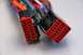 2003 Ford Taurus - Close-up of two red wiring harness connectors with many colored wires.