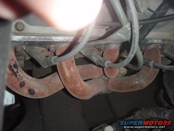 Close-up of engine's exhaust manifold and spark plug wires