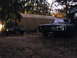 1969 Ford Torino - Two cars are parked outdoors in front of a large tent at dusk.