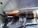 2003 Ford Taurus - Close-up of a Ford electronic control module, showing connected wiring harnesses and part number.