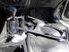 2003 Ford Taurus - The center console of a car shows a gear shifter and a removed trim piece, suggesting a repair or modification.
