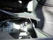 2003 Ford Taurus - Detail of a mounting bracket and wiring harness located beneath the vehicle's seat.