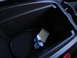 2003 Ford Taurus - An iPod is plugged into a cable inside the dark center console of a vehicle.