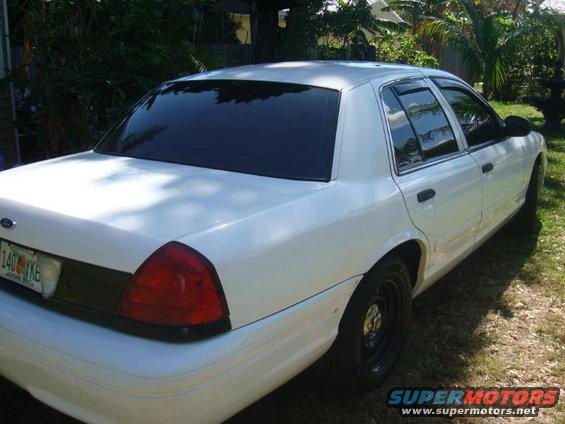 White 2002 Ford Crown Victoria, rear quarter view with tinted windows