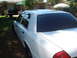 2002 Ford Crown Victoria - White 2002 Ford Crown Victoria with tinted windows parked outdoors.