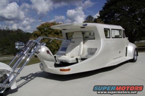 White custom motorcycle limousine with a chopper front and a long passenger cabin