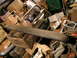 1979 Ford Bronco - A collection of assorted vehicle parts and storage boxes are piled together in a cluttered space.