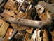 1979 Ford Bronco - A collection of automotive parts, including a bumper, are stored amongst cardboard boxes.