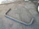 1979 Ford Bronco - Exhaust pipe part shown on asphalt with a tire visible on the right.