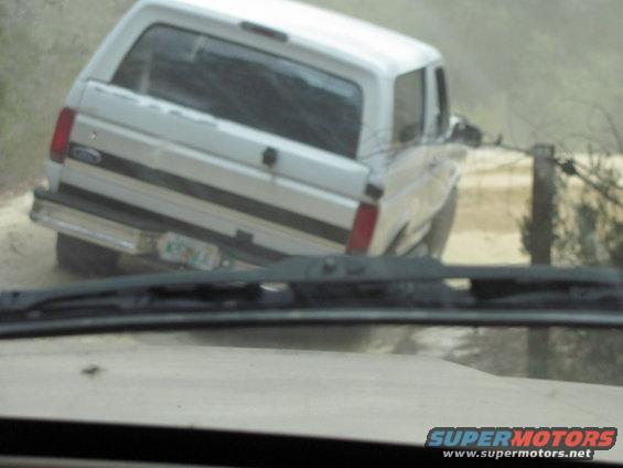 1990 Ford Bronco rear view, white, driving off-road