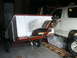1990 Ford Bronco - Trailer with white box attached to a 1990 Ford Bronco in a garage.