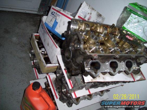 engine block and cylinder head stacked with boxes, orange jug nearby