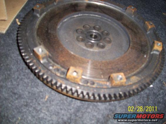 Rusty flywheel with gear teeth and bolt holes