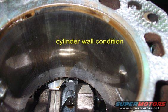 Close-up of an engine cylinder wall showing scoring and wear