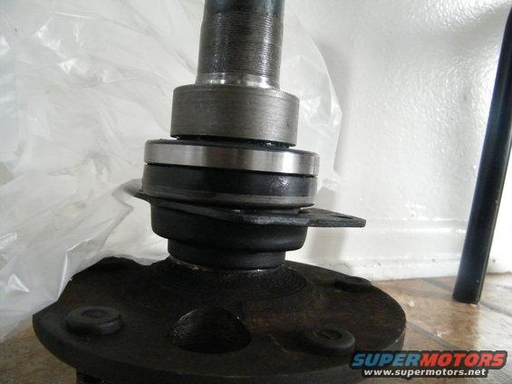 Wheel bearing and spindle assembly with rubber boot and metal plate