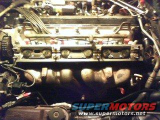 Cam cover removed on exhaust camto install tappet guide hold down kit.