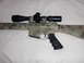 1991 Ford Bronco - A rifle with a scope, painted in a camouflage pattern, is shown against a white background.