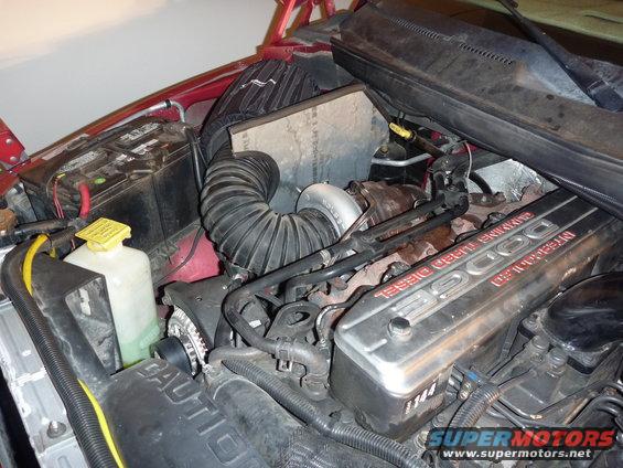 Engine bay of a 1997 Dodge 2500 showing the turbocharger and intake hose