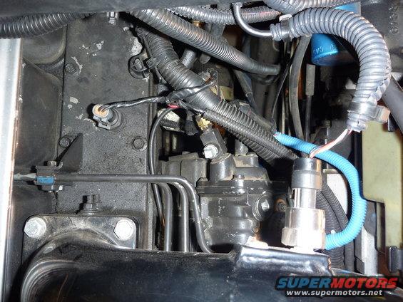 Close-up of a diesel engine's fuel injection pump and associated lines and wiring