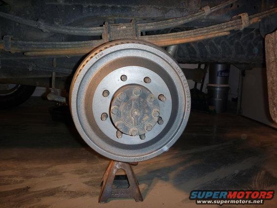 Rear drum brake assembly on jack stands, showing leaf springs above