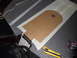 1993 Tracker Tournament - A cardboard cutout is being used as a template on a carpeted surface, with tools nearby for modification.