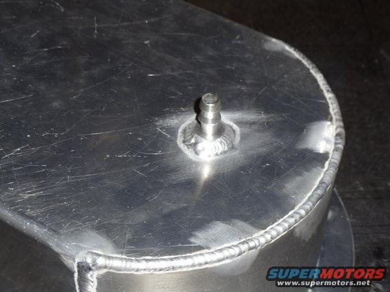 Aluminum part with barbed fitting and visible welds