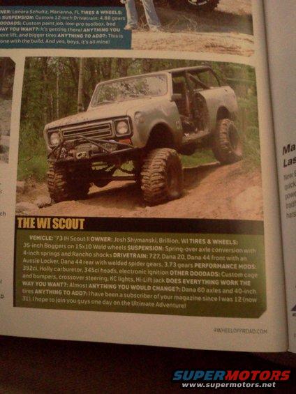 1973 IH Scout II with large off-road tires and custom roll cage, parked on dirt