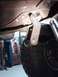 1971 International School Bus - A close-up view of a vehicle's undercarriage, focusing on a suspension component.