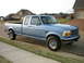 1995 Ford Bronco - This 1995 Ford F-150 pickup truck is parked on the side of a suburban street.