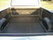 1995 Ford Bronco - The interior of a Ford pickup truck bed shows the iconic Ford oval emblem.