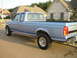 1995 Ford Bronco - This blue Ford F-Series pickup truck is shown from the rear 3/4 angle.