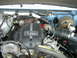 1995 Ford Bronco - Close-up of a diesel engine's turbocharger and intake system, with visible text on the cover.