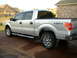 1995 Ford Bronco - This silver pickup truck has a 4x4 OFFROAD decal on its rear fender and chrome wheels.