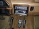1990 Ford Bronco - The dashboard of a 1990 Ford Bronco features wood trim, a floor shifter, and an aftermarket stereo system.