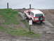 1991 Ford Bronco - This two-tone Ford Bronco navigates a challenging off-road course with a muddy incline.