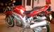 2003 Suzuki SV1000S - A red 2003 Suzuki SV1000S motorcycle is parked in what appears to be a garage.