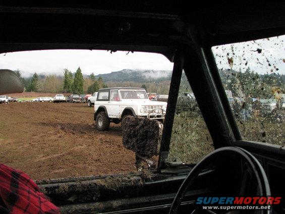 White 1978 Ford Bronco in mud, 3q-front view
