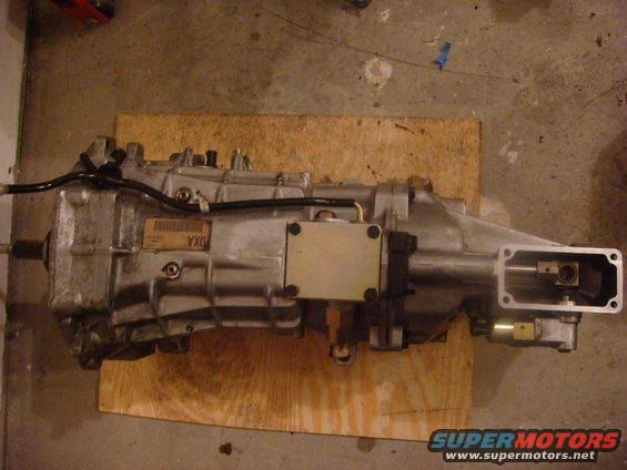 Silver transmission with a label reading 'DXA' and a metal plate attached
