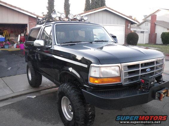 Black 1993 Ford Bronco with roof lights and aftermarket bumper