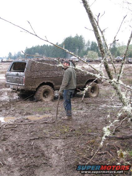 1978 Ford Bronco stuck in mud, being towed