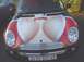 1984 Ford Bronco II - This Mini Cooper features a provocative graphic on its hood, alongside a license plate and Supermotors.net watermark.