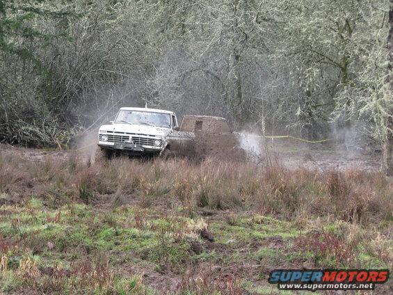 White pickup truck in mud, 1970s style grille