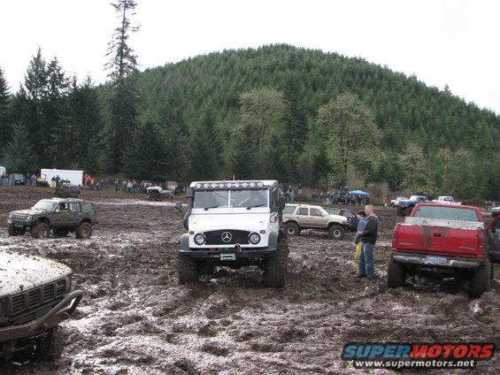 White Mercedes-Benz Unimog in mud, front view